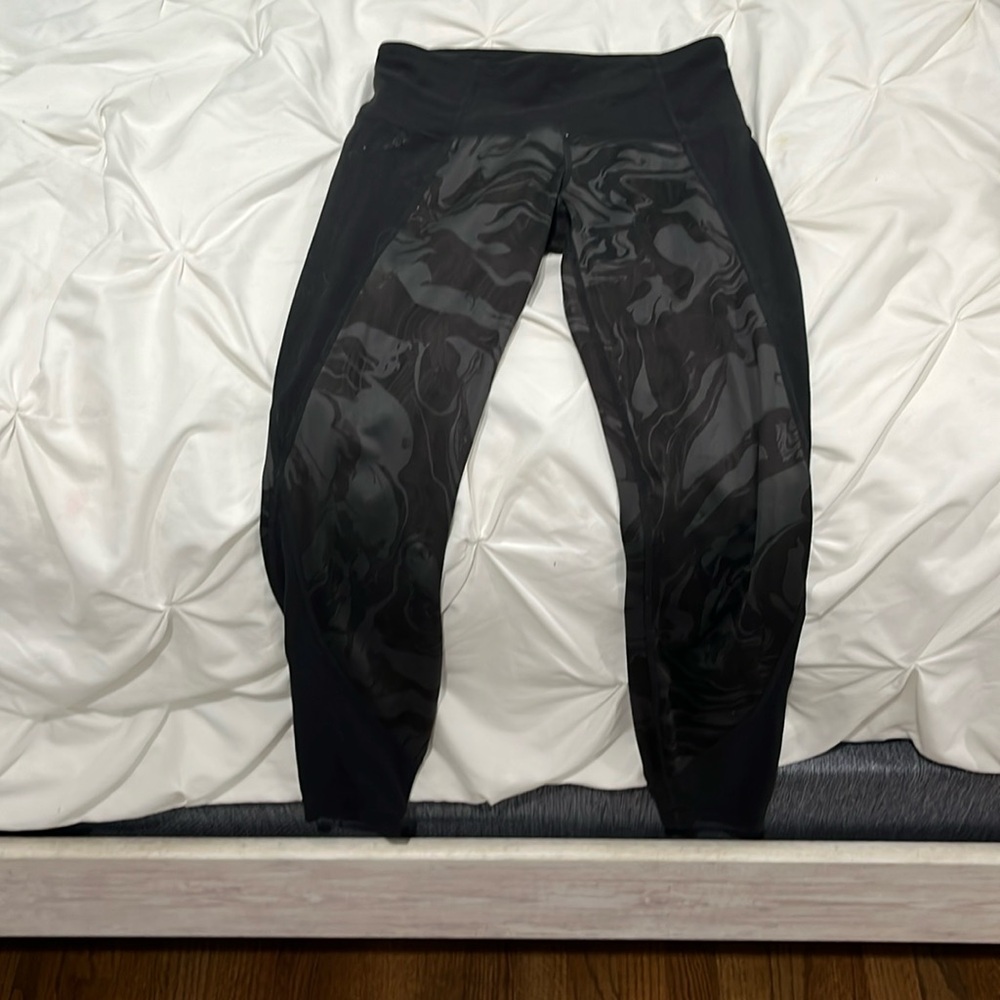 black Athleta leggings with swirling design